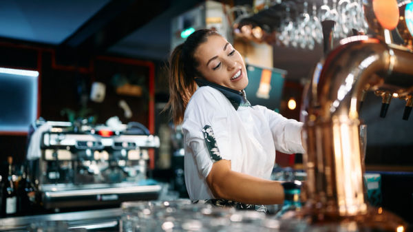 A bartender talking on phone