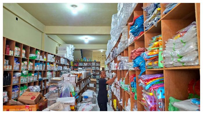 TATA DAGANGAN - Seorang pedagang plastik di Palangka Raya yang sedang menata dagangannya, Jumat (3/4/2026).