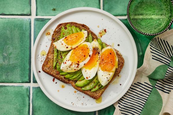 a recipe photo of the Jammy Egg & Avocado Toast Credit: Photographer: Robby Lozano, Food Stylist: Margaret Dickey, Prop Stylist: Julia Bayless