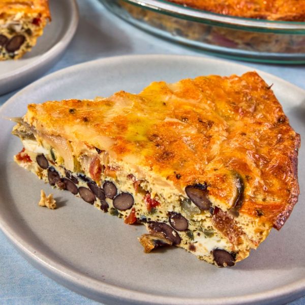 A slice of quiche with black beans and pepper jack cheese on a plate Credit: Photographer: Jen Causey, Food Stylist: Emily Nabors Hall, Prop Stylist: Julia Bayless.