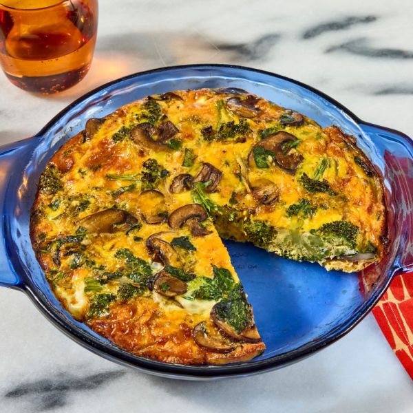 Recipe image of Spinach, Broccoli & Mushroom Quiche Credit: Photographer: Jen Causey, Food Stylist: Chelsea Zimmer, Prop Stylist: Claire Spollen