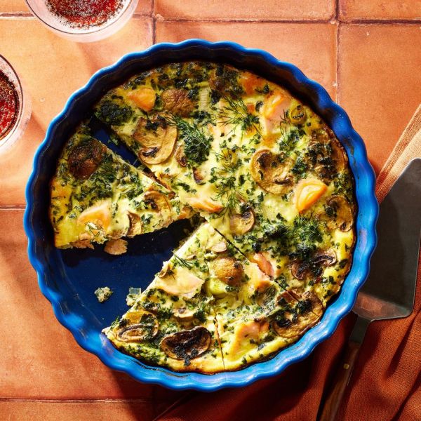 an image of the Crustless Salmon, Leek & Mushroom Quiche in a blue dish Credit: Photographer: Brie Goldman, Food Stylist: Annie Probst, Prop Stylist: Joseph Wanek