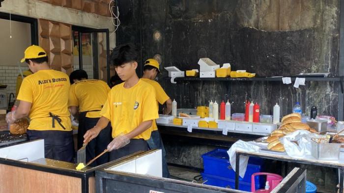 SIAPKAN BURGER - Kru Aldi’s Burger memanggang patty daging di atas bara api, memastikan Burger Aldi's yang juicy siap untuk dihidangkan, Sabtu (4/4/2026).