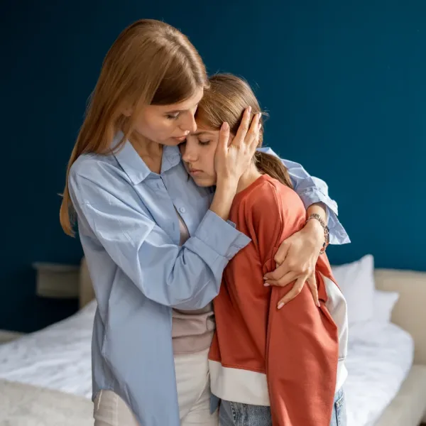 mom comforting daughter after cat passes away teaching her not to suppress grief