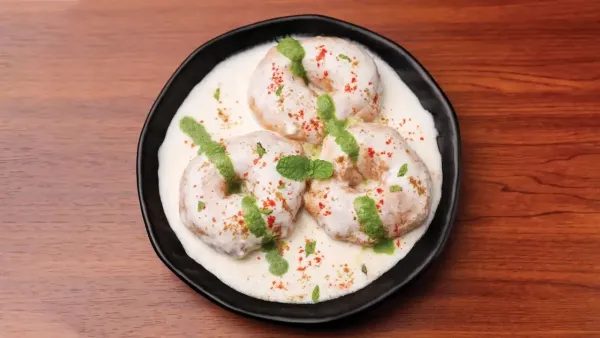 Distorted and flipped image of a person with curly hair and dark clothing, partially obscured and unclear.