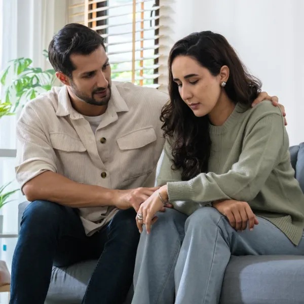 parents sitting on couch and deciding how to split responsbilities