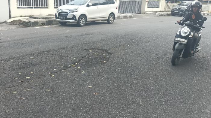 JALAN BERLUBANG - Potret Lubang jalan di seputaran Gedung KONI Sario Manado Sulawesi Utara.