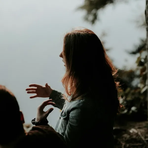 woman gesturing hands while talking