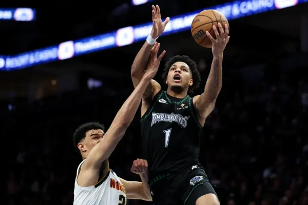 Terrence Shannon Jr., who scored 24 points in a surprise start, goes up for a layup as Spencer Jones defends during the Timberwolves' Game 6 series-clinching win over the Nuggets.