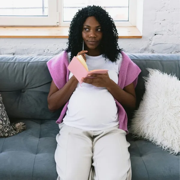 pregnant woman making a list of possible baby names