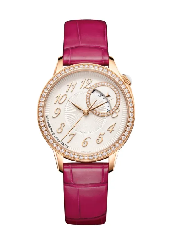 Vacheron Constantin watch with a magenta leather band, rose gold case, and a white dial with diamond accents.