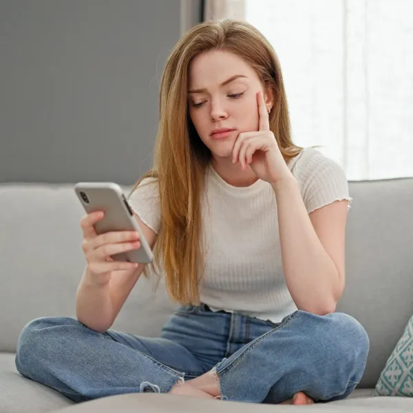 bored woman looking at smartphone