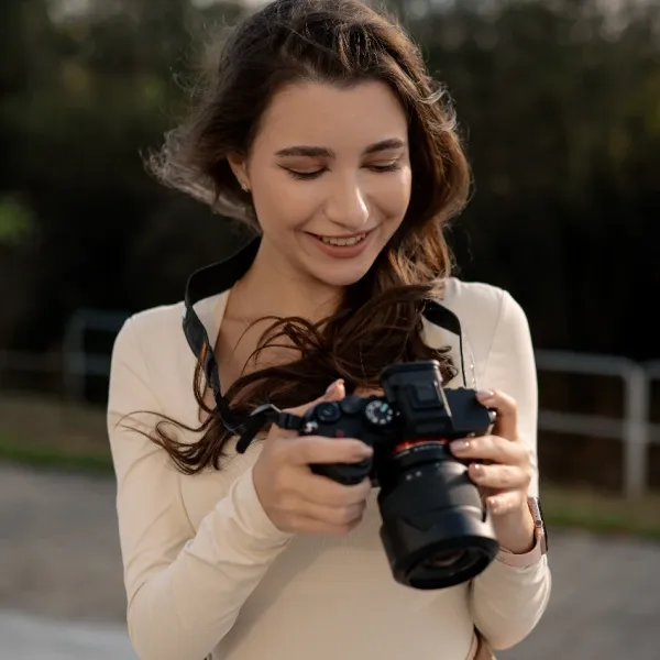 smiling woman holding camera outside understand the geometry of images