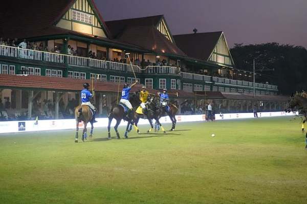 Players from team - Captain E. L. Maryyat and Lieutenant C. L. Young battle for possession under lights with the iconic club house of Bombay Gymkhana in the backdrop during the third edition of the Standard Chartered Bombay Gymkhana Arena Polo Championship