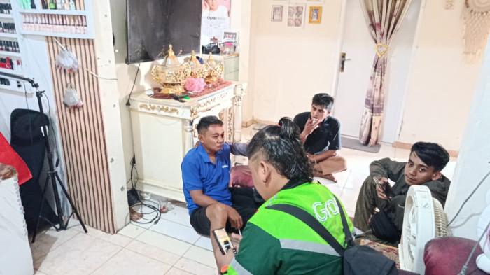 KEMBALI KE RUMAH -- Isten Laiya (pria berbaju biru) saat berada di rumah keluarganya. Istri Isten mengungkap gelagat aneh sang suami sepekan sebelum ramai diberitakan melompat di jembatan. (TribunGorontalo.com/Jefry Potabuga)