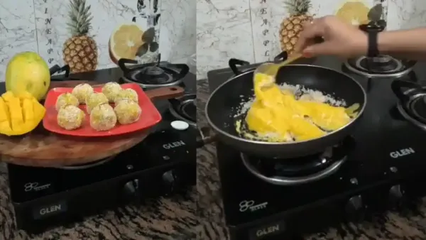 : A person cooking mango puree with coconut in a pan to prepare delicious homemade mango sabudana laddoo sweets.