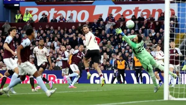 BIRMINGHAM, ENGLAND - MAY 15: Morgan Rogers of Aston Villa scores his team's first goal past Giorgi Mamardashvili of Liverpool during the Premier League match between Aston Villa and Liverpool at Villa Park on May 15, 2026 in Birmingham, England. (Photo by Harry Murphy - AVFC/Aston Villa FC via Getty Images)