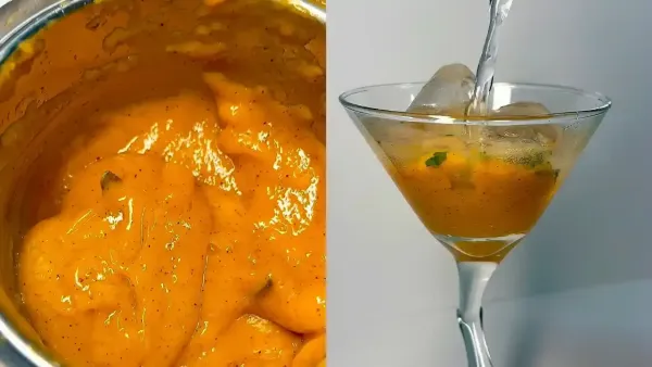 Fresh mango puree in a blender next to a martini glass being filled with chilled water and ice.