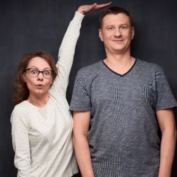 woman pointing out how tall a man is