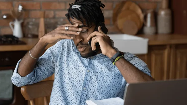 Man who needs a break looks stressed in front of a computer at home