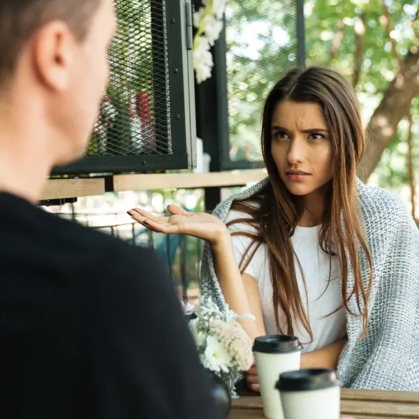 intelligent woman playing dumb while talking to man