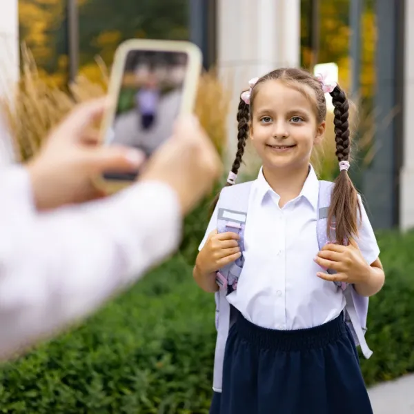 teacher taking a picture of a student to post