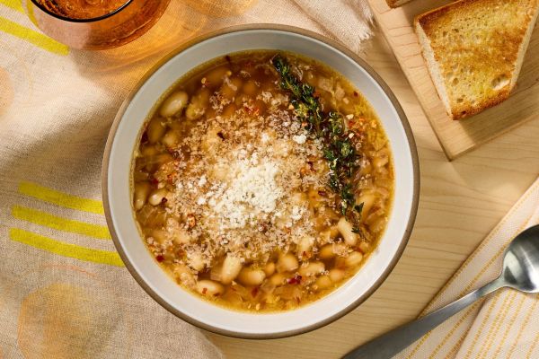 an image of the Brothy Lemon-Garlic Beans Credit: Photographer: Robby Lozano, Food Stylist: Amanda Holstein, Prop Stylist: Abby Armstrong