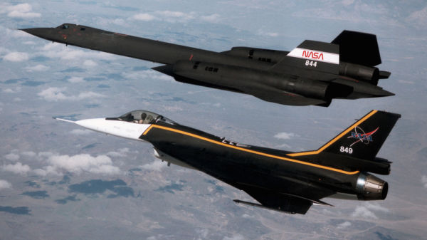 An F-16XL fighter plane follows an SR-71A reconnaissance aircraft in flight