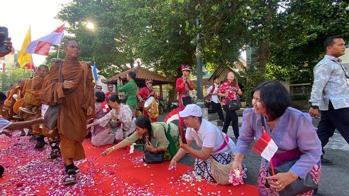 SAMBUTAN - Sebanyak 57 Bhikkhu Thudong disambut meriah dengan taburan bunga dan kibaran bendera Merah Putih saat tiba di Kompleks Kepatihan, Daerah Istimewa Yogyakarta, Senin (25/5/2026). Penyambutan hangat dari warga ini menjadi bagian dari agenda Indonesia Walk For Peace (IWFP) 2026, yang merupakan rangkaian peringatan Waisak 2570 BE. Diiringi berbagai atraksi, termasuk barongsai, para biksu yang tengah menjalani laku spiritual berjalan kaki sejauh 666 kilometer dari Bali menuju Candi Borobudur ini diterima langsung oleh Gubernur DIY, Sri Sultan Hamengku Buwono (HB) X.