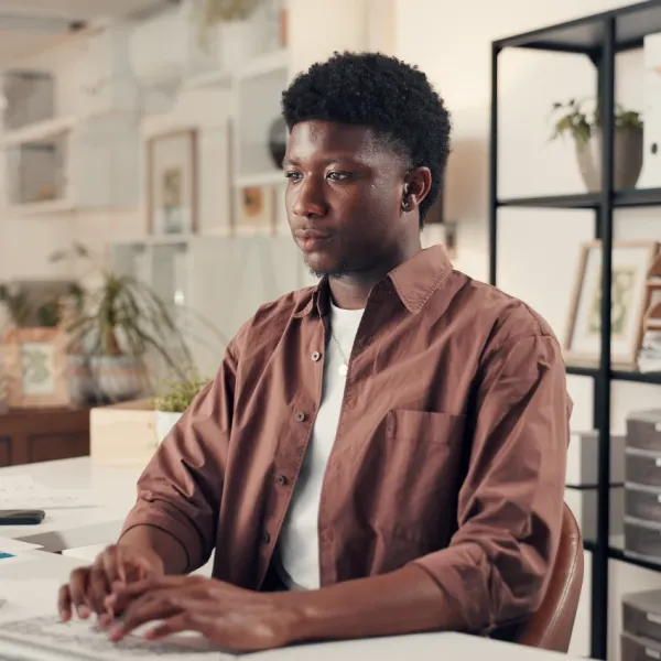 intelligent man typing on keyboard avoiding groups of three in lists