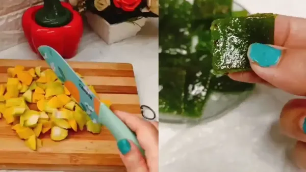 Hand chopping fresh raw mangoes on a wooden board next to delicious, translucent green kacha aam papad slices.