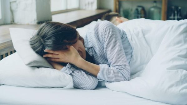A person struggling to sleep. Photo by Pexels