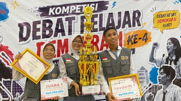 JUARA DEBAT PELAJAR - Tim Smansa Synergy dari SMAN 1 Sebatik berpose usai menerima trofi Juara 1 Grand Final Kompetisi Debat Pelajar Demokrasi ke-4 tingkat SMA/MA se-Kabupaten Nunukan di Lantai V Kantor Bupati Nunukan, Jumat (5/6/2026). Tim yang diperkuat Syahrani Ramadhani, Nur Asyikin, dan Muhammad Gionando berhasil mengungguli Rosita Institute dari SMAN 1 Nunukan dalam debat bertema Pemilihan Kepala Daerah melalui DPRD.