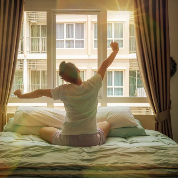 woman with vivid images in her dreams waking up in the morning