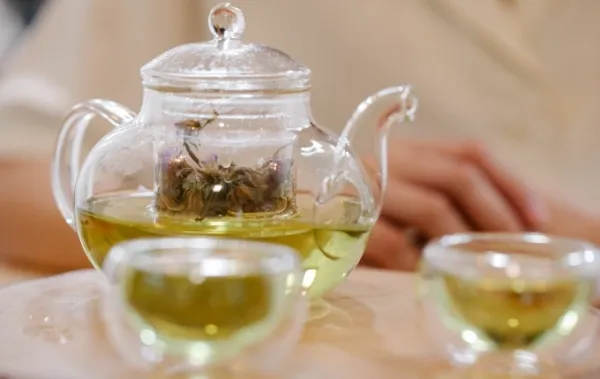A glass pot of green tea. Photo by Pexels