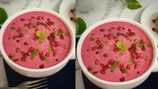 Two bowls of vibrant pink beetroot cucumber raita garnished with fresh pomegranate seeds and mint leaves on a table.