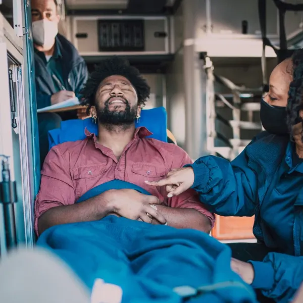 paramedics caring for a man riding in an ambulance