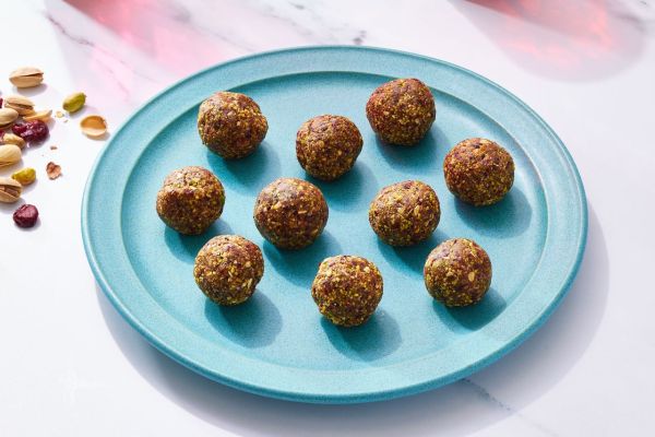 a recipe photo of the Cranberry-Pistachio Energy Balls Credit: Photographer: Brie Goldman, Food Stylist: Addelyn Evans, Prop Stylist: Gabriel Greco