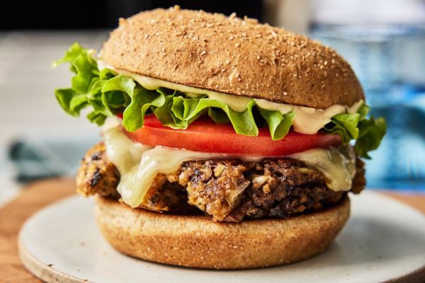 A recipe image of Black Bean & Veggie Smash Burgers. Credit: Photographer: Greg Dupree, Prop Stylist: Julia Bayless, Food Stylist: Chelsea Zimmer.