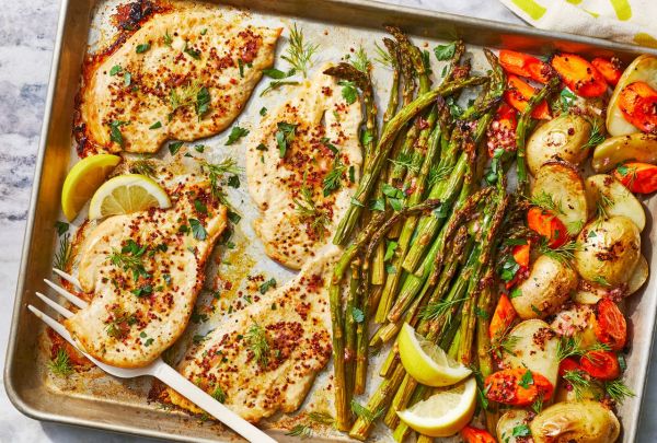 Overhead view of a baking sheet of One-Pan Chicken & Asparagus Bake recipe Credit: Photography: Caitlin Bensel, Food Styling: Emily Nabors Hall