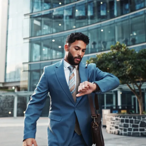 businessman checking his watch rushing to work