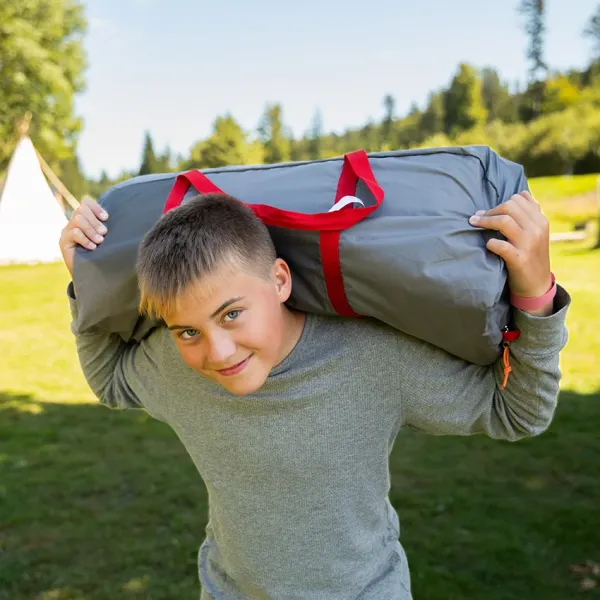 teenage boy carrying a camping pack