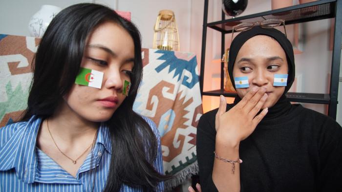 Dua wanita mengenakan striker Aljazair (kiri) dan Argentina (kanan) di wajah sebagai bentuk dukungan pada Piala Dunia 2026, di Kota Solo, Jawa Tengah, Senin (15/6/2026).