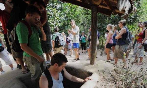 Foreign tourists climb into the underground network during a tour to Saigons Cu Chi Tunnels. Photo by AFP