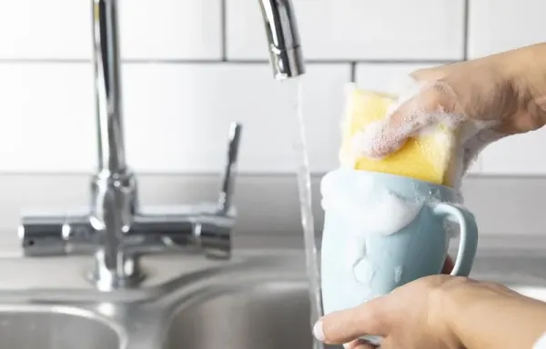 Woman is washing coffee cup.