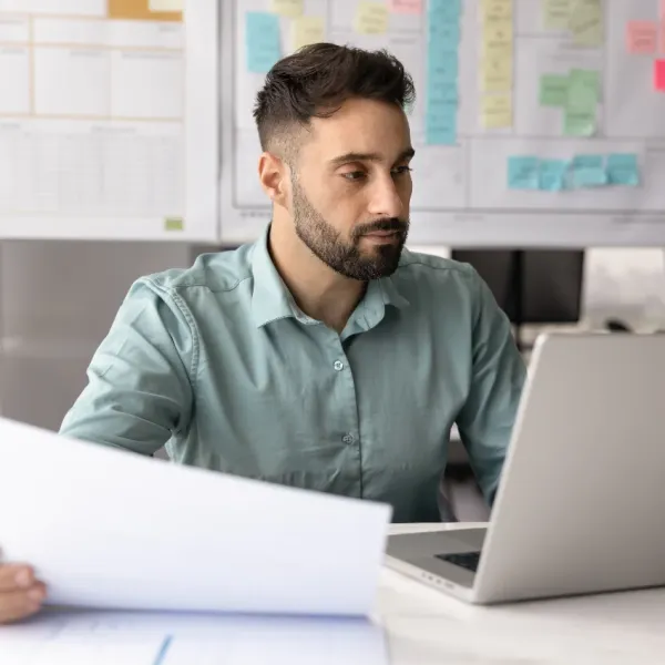 serious millennial man working at desk