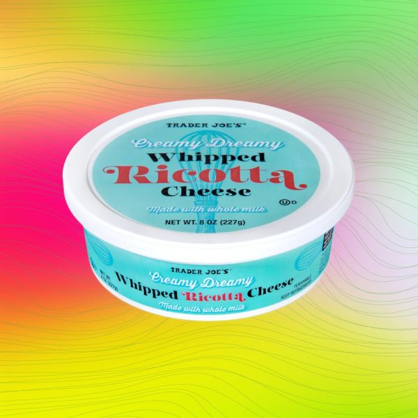 Trader Joes Whipped Ricotta Cheese container on a colorful background Credit: Trader Joe's. EatingWell design.
