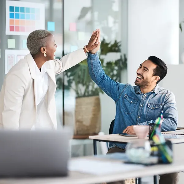 two business people high fiving, positive feedback
