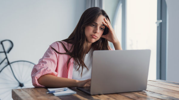 Frustrated woman using a laptop