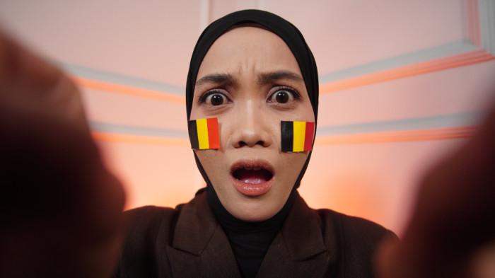 Wanita asal Karanganyar mengenakan stiker Belgia di wajah sebagai bentuk dukungan dalam Piala Dunia 2026, di Kota Solo, Jawa Tengah, Senin (15/6/2026).(Tribun-Video.com/Akmal Khoirul Habib)